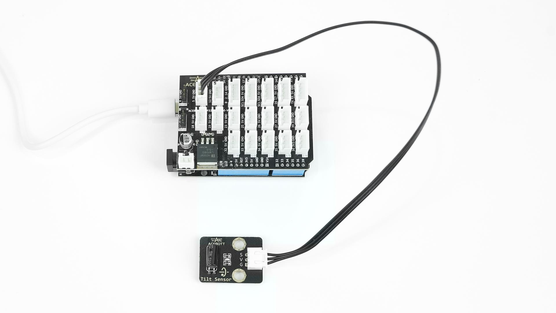 4ACEBOTT QB123 Tilt Sensor module connected to an ESP32 controller board with cable for tilt detection testing