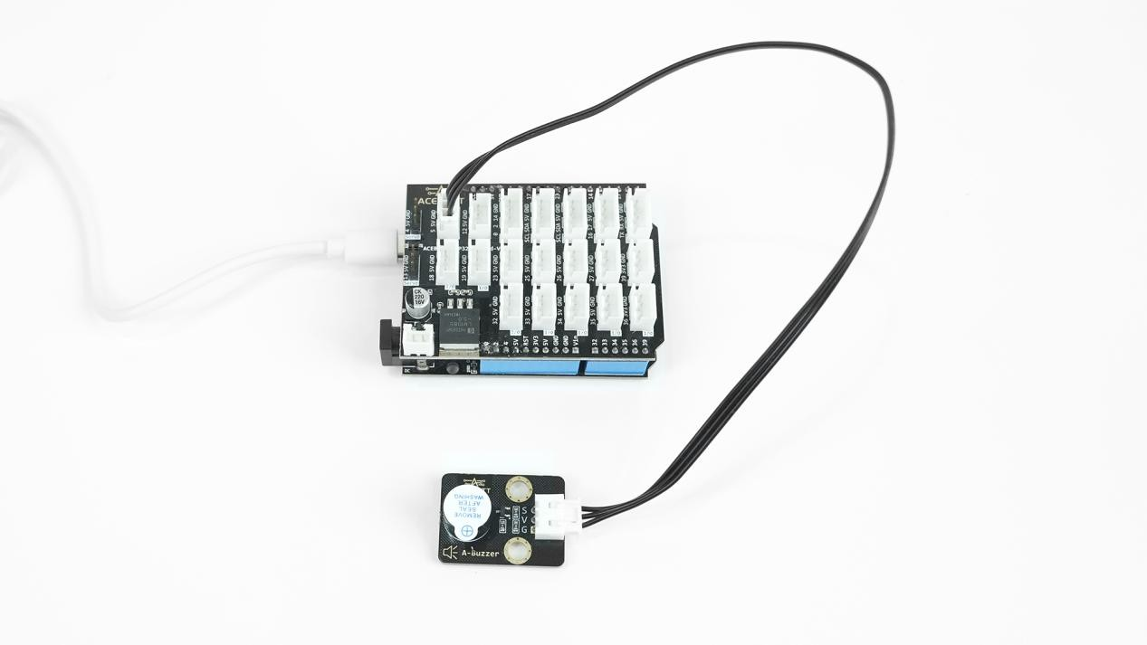 4ACEBOTT QB124 Active Buzzer module connected to an ESP32 controller board with cable for buzzer operation testing