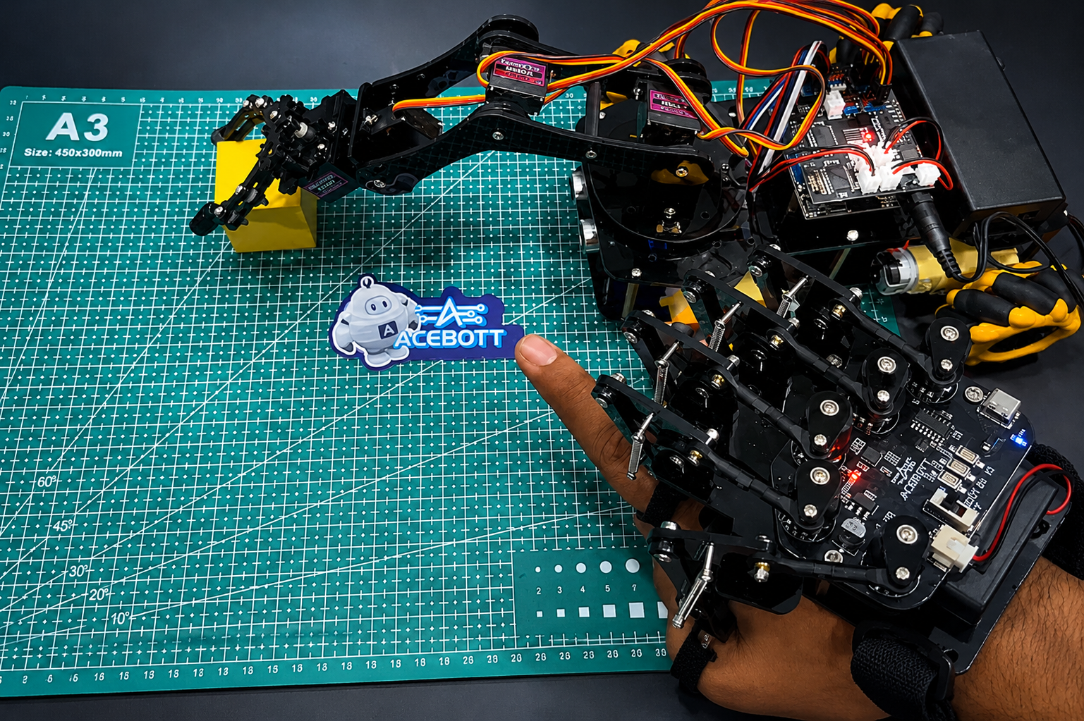 ACEBOTT QD023 Motion Sensing Glove controlling a robot arm car